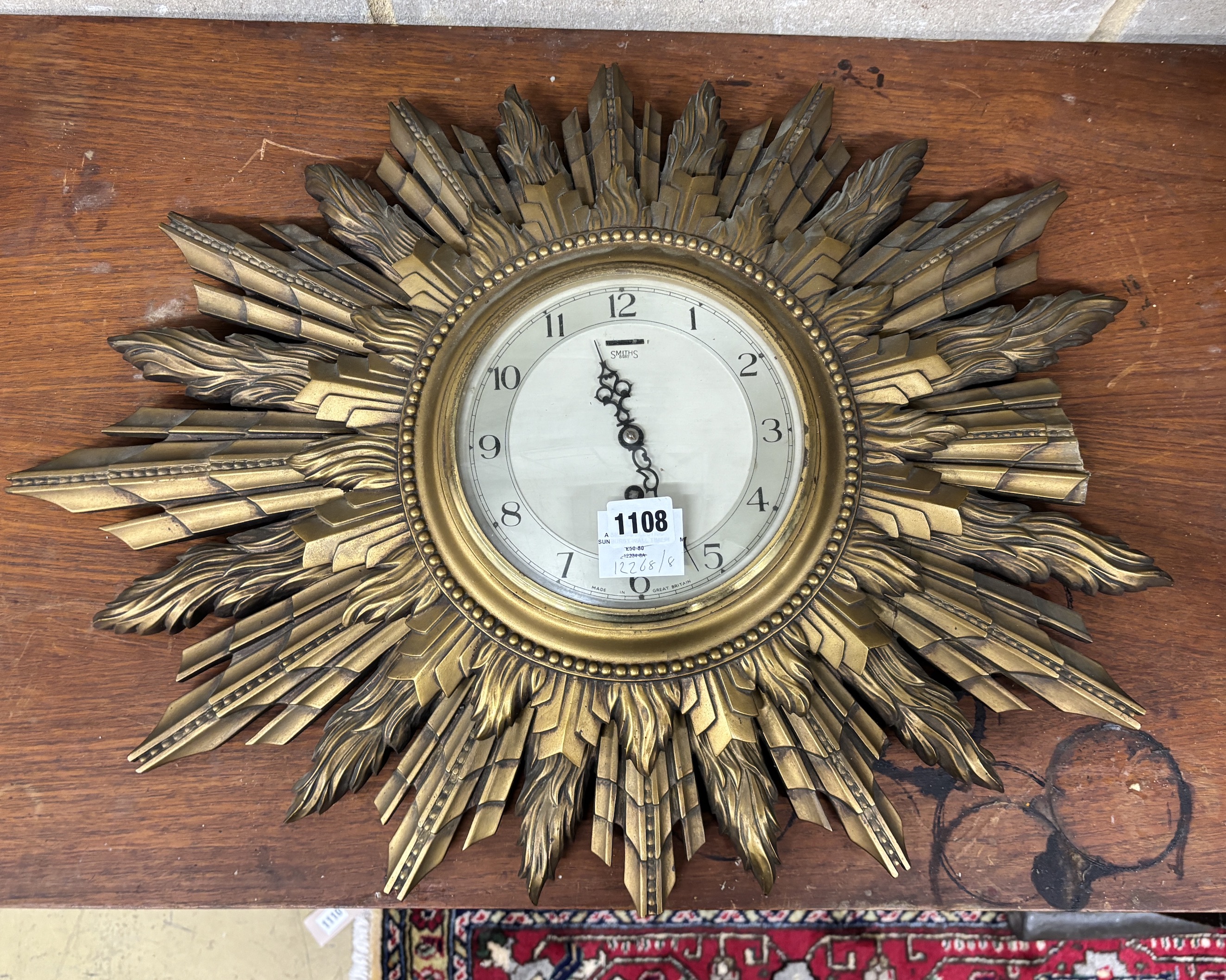 A Smith's electric sunburst wall timepiece, width 82cm, height 47cm (a.f.)